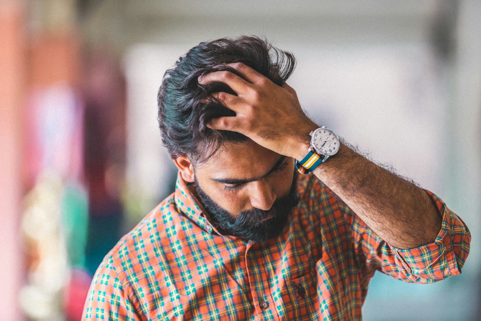 An indian man looking stressed out thinking about microaggressions