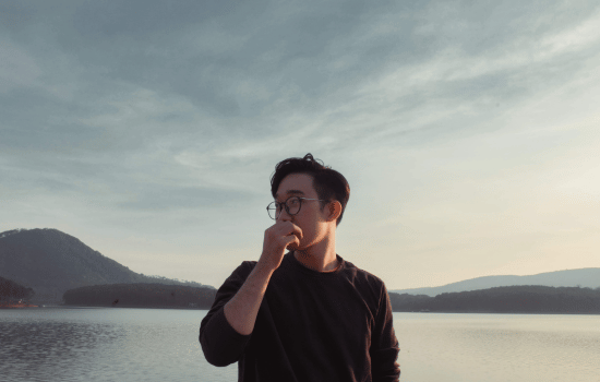 person in front of the lake