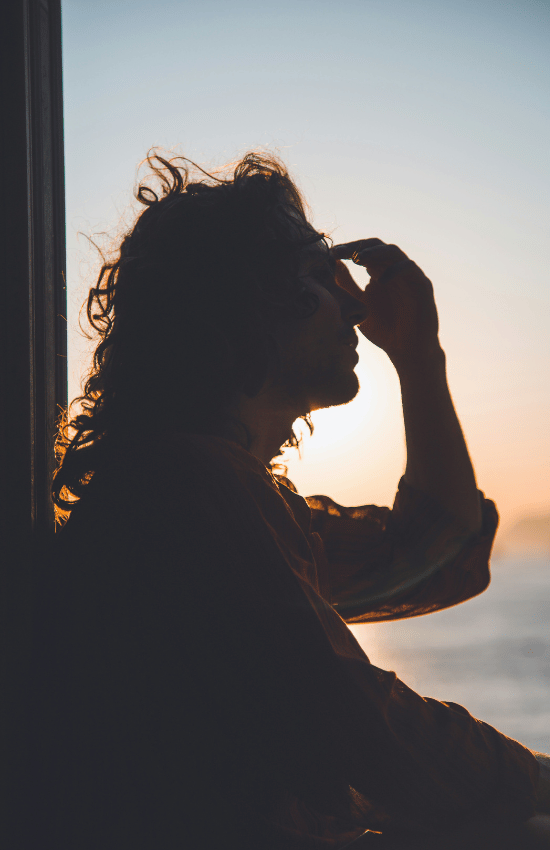 Woman touching her forehead as she thinks about stress counseling Seattle.